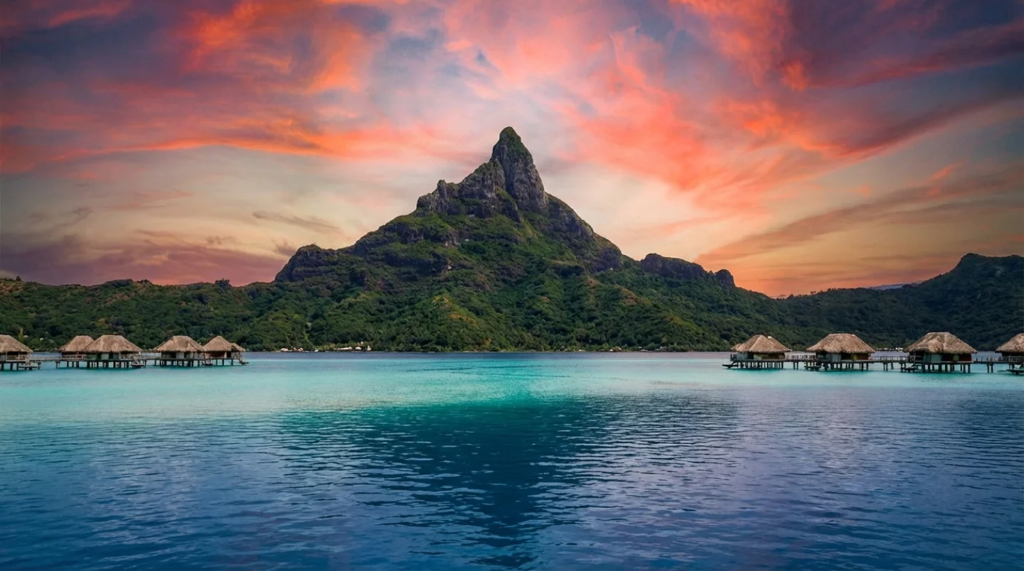Spectacular overwater panorama in Bora Bora with Mount Otemanu at sunset